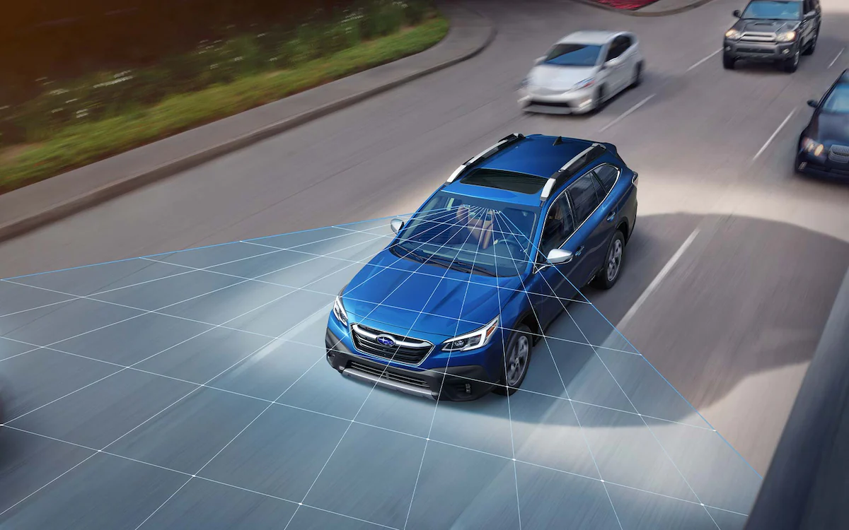 A photo illustration showing the EyeSight® Driver Assist Technology sensors on a 2022 Subaru Outback driving down a highway.