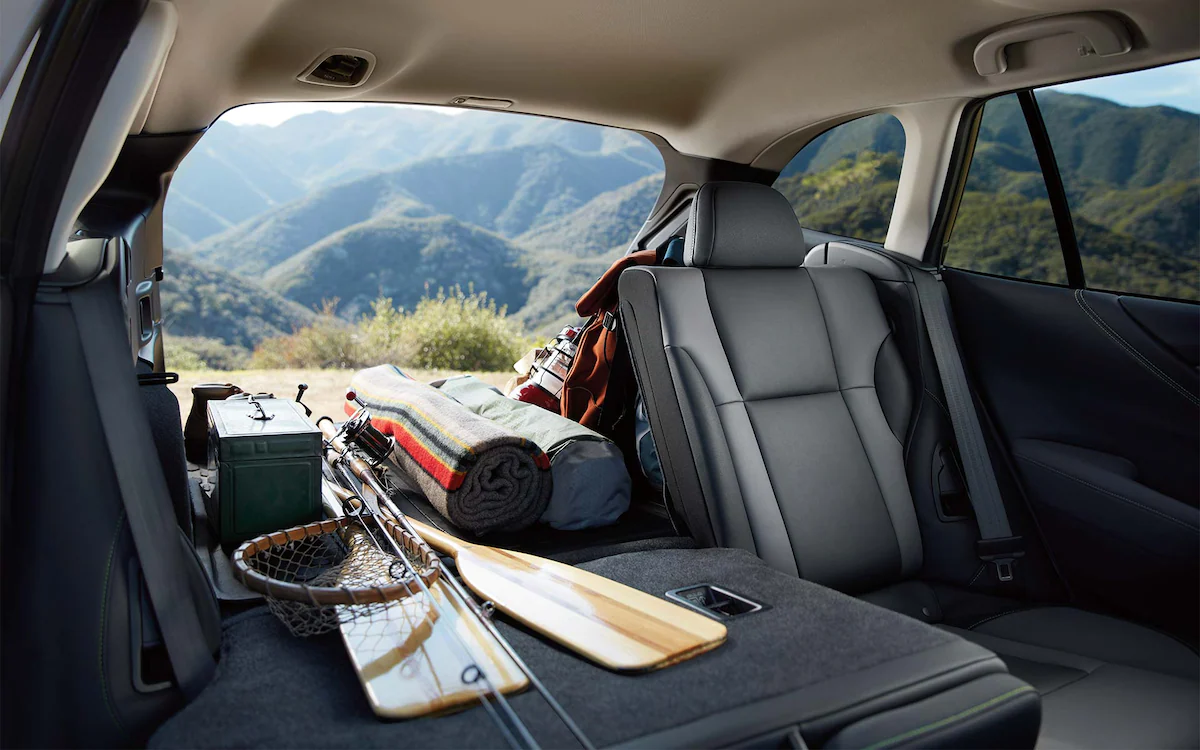 A view from inside the 2022 Subaru Outback showing the cargo area filled with outdoor gear and part of the rear seat folded down.